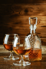 Cognac or whiskey in glasses on rustic backgrpund