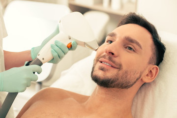 Portrait of the man at laser hair removal procedure