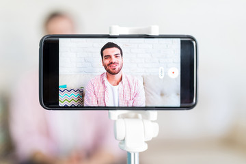 Smartphone screen recording a content creator talking at home