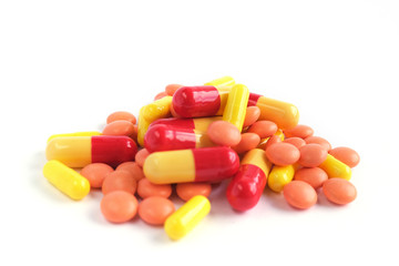 Multicolor tablets on white background. Epidemic, painkillers, healthcare, treatment pills and drug abuse concept. top view. flatlay