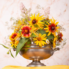 Still life with bright summer flowers on a light background