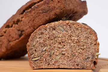 Two loaves of rye bread on a white background