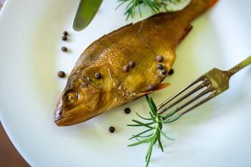 smoked flavored fish on a plate with spices