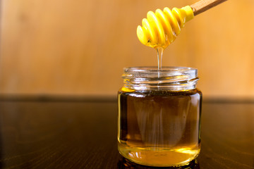 honey in glass jar with dipper