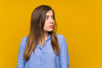 Fototapeta premium Young girl with striped shirt standing and looking side