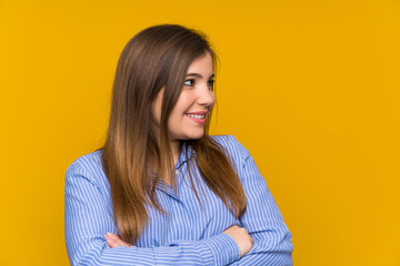 Obraz premium Young girl with striped shirt standing and looking to the side