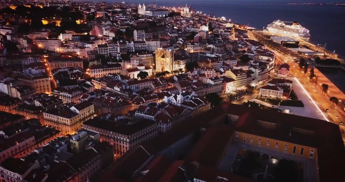 Night aerial view of downtown of Lisbon overlooking medieval Cathedral and Castle of Sao Jorge, Portugal