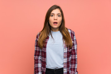 Fototapeta premium Young girl over pink wall with surprise facial expression