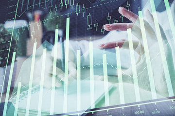 Forex chart displayed on woman's hand taking notes background. Concept of research. Multi exposure