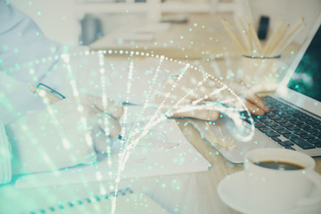 DNA hologram with businessman working on computer on background. Concept of bioengineering. Double exposure.