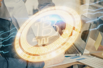 Crypto currency theme hologram with businessman working on computer on background. Concept of blockchain. Multi exposure.