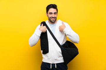 Young sport man over isolated yellow wall with surprise facial expression