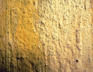 part of yellow wall with cracked paint