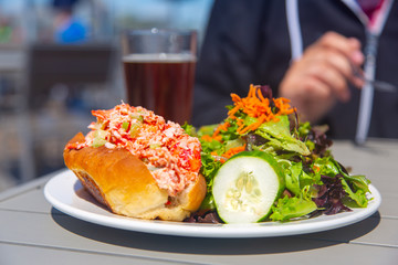 Lobster roll with salad and beer