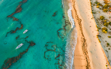 Anakao beach, South West Madagascar. Aerial photo of the coastline with boats on anchor.  - obrazy, fototapety, plakaty