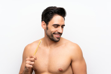 Fototapeta premium Man brushing teeth over isolated white background