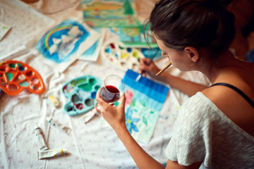 Woman enjoy in painting with glass of vine