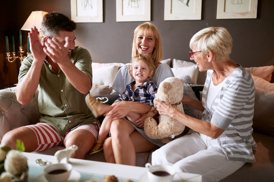 Parents And Grandma Playing With Child