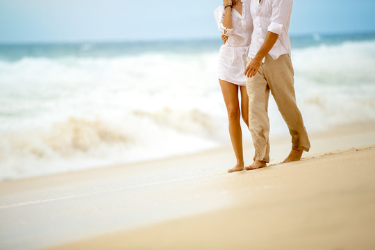couple walking on sandy beach