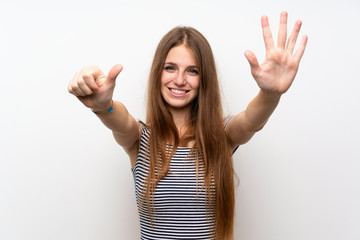 Young woman with long hair over isolated white wall counting six with fingers