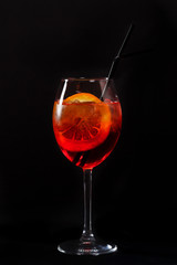 bright red drink aperol syringe on a black background