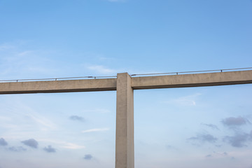 Fototapeta na wymiar High-rise building top cross cement beams under blue sky background