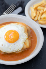 typical portuguese dish francesinha in dish on ceramic background