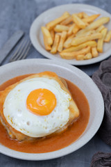typical portuguese dish francesinha in dish on ceramic background