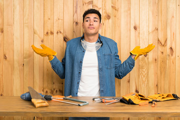 Craftsmen man over wood background having doubts with confuse face expression