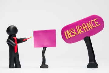 A man made from plasticine making a presentation about insurance, on white background.