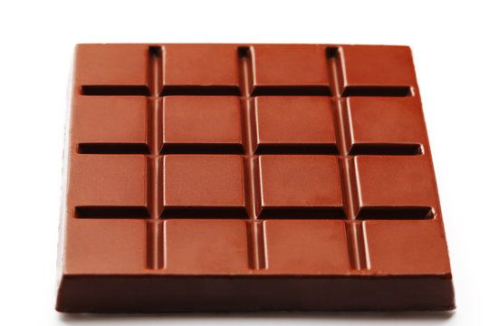 Square-shaped milk chocolate on a white background from above. Isolated A whole plate of dark chocolate isolated on white from above