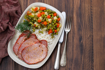 fried meat with vegetables in white dish
