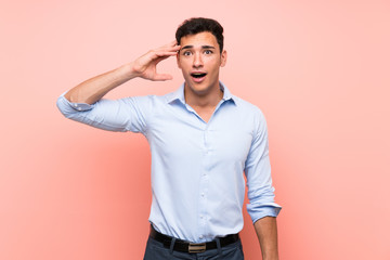 Handsome man over pink background has just realized something and has intending the solution