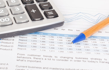 sheet of  investment report with pen,and calculator
