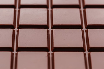 Milk chocolate close up. Segments of chocolate in the macro. Full frame texture