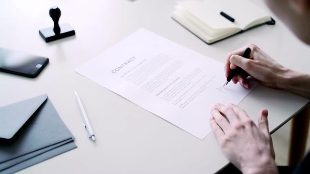 Woman fills data in graphs on paper. Records information. Woman is engaged in office work. Graphic charts,indicators. Woman works at the offside table. Woman draws symbols on the paper