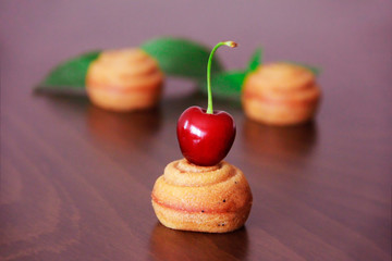 biscuit cupcake cupcake with cherry and green leaf decorations