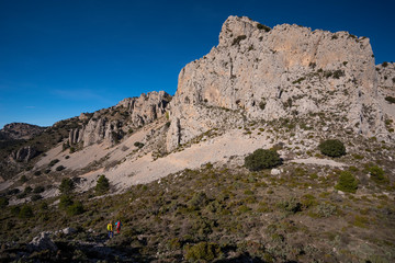 Two women hiking in Sierra de Serrella, Quatretondeta-Confrides, Alicante province, Comunidad Valenciana region, Spain
