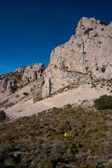 Fototapeta na wymiar Two women hiking in Sierra de Serrella, Quatretondeta-Confrides, Alicante province, Comunidad Valenciana region, Spain
