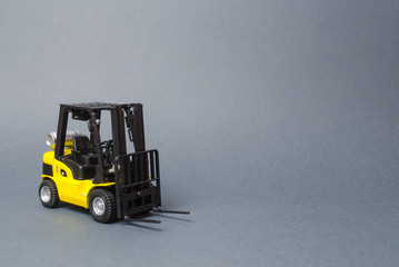 Yellow forklift truck on gray background. Warehouse equipment, vehicle. Logistics and transport...