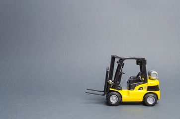 Yellow forklift truck side view on gray background. Warehouse equipment, vehicle. Unloading,...
