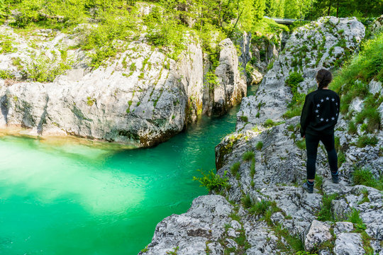 Young girl looking at the Soca River in Lepena 