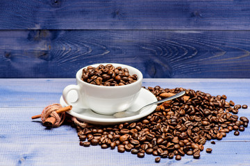 Coffee shop concept. Cafe drinks menu. Coffee break and relax. Fresh roasted coffee beans. Caffeine concept. Inspiration and energy charge. Cup full coffee brown roasted bean blue wooden background