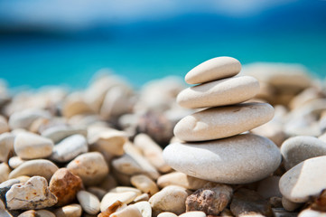 Fototapeta na wymiar Feng Shui elements. Concept harmony. White stones and turquise sea in moments of relaxation. Beautiful beach with sand and stone. Zen stones sand. Mikros Gialos beach, Lefkada, Greece.