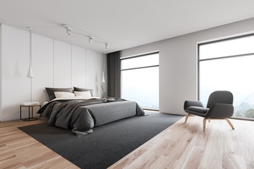 White loft master bedroom corner with armchair