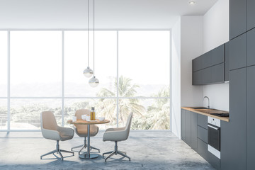 Panoramic white kitchen with beige chairs