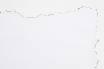 Cropped flat lay of torn and burnt paper on white surface. Aged effect. Abstract background. Copy...