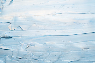 Sky blue acrylic paint. Decorative art abstract background. Smeared colored foam surface.