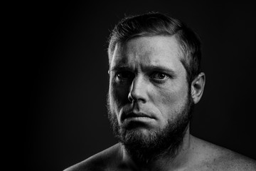 Portrait of a man with a beard on a black background