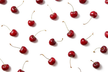 Ripe red cherries arranged on white background isolated